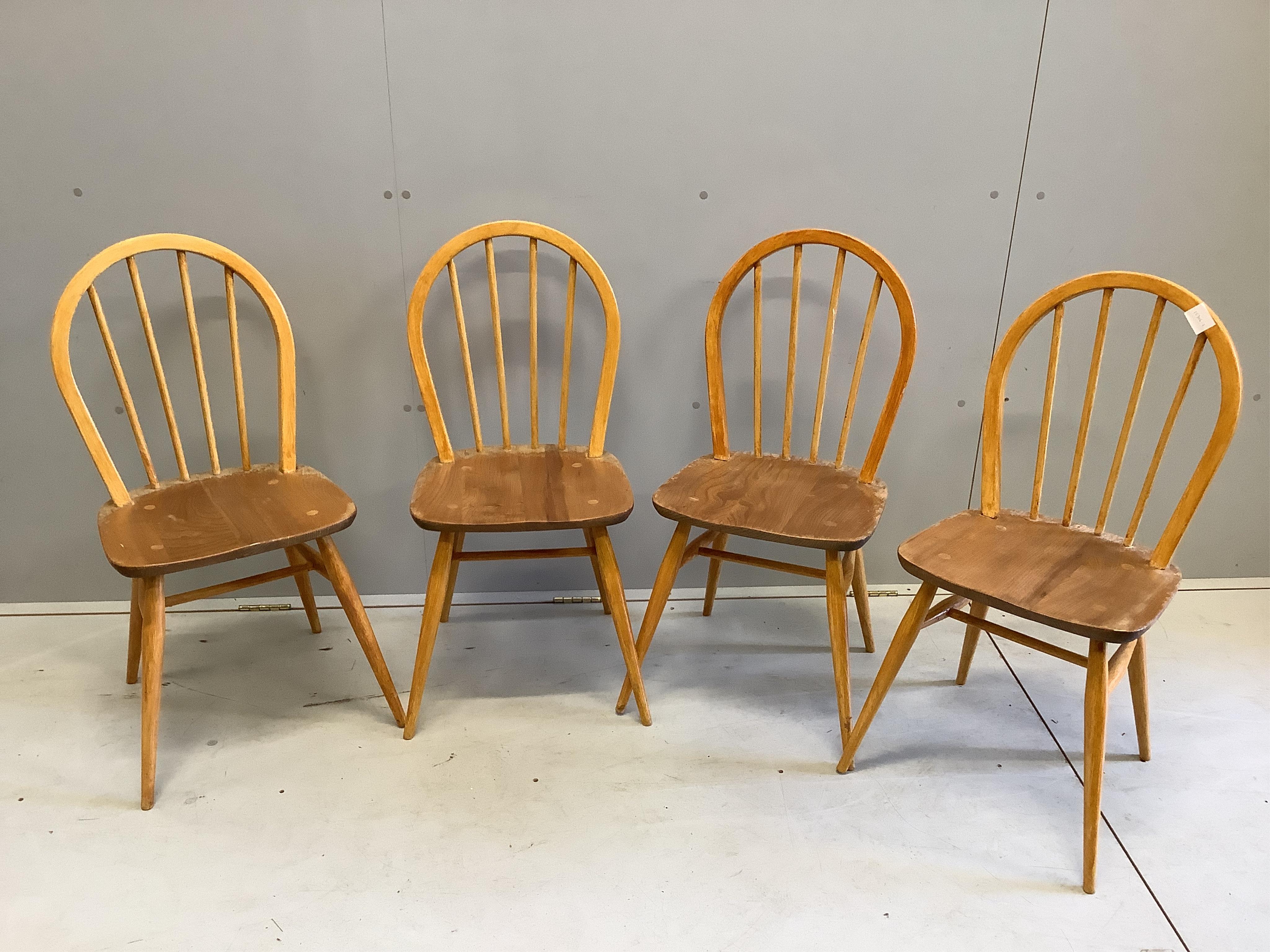 A set of four mid century Ercol style elm and beech comb back dining chairs, height 85cm. Condition - poor to fair